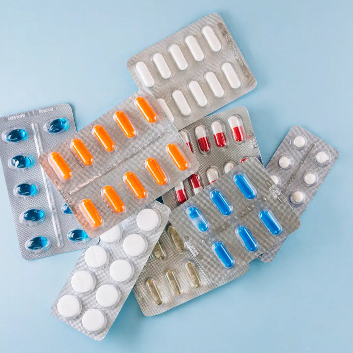 Packs of medicine rest on a pharmacy counter