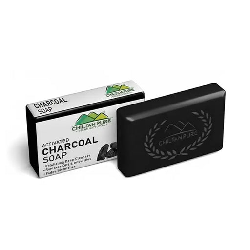 Black charcoal soap bar with packaging on a white background