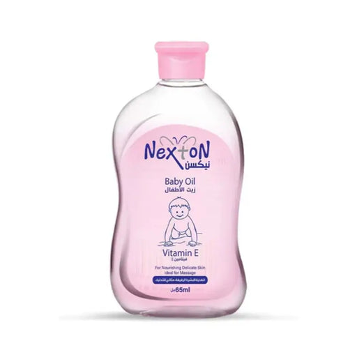 Bottle of Nexton Baby Oil with Vitamin-E, pink cap, 65ml size, labeled in Arabic.