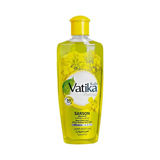 Vatika hair oil bottle with yellow cap on a white background